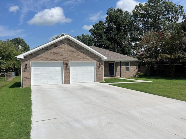 ranch-style house featuring brick siding, a garage, concrete driveway, and a front yard