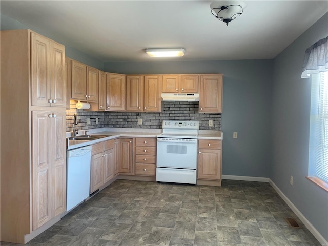 kitchen with white appliances, light brown cabinets, a sink, light countertops, and under cabinet range hood