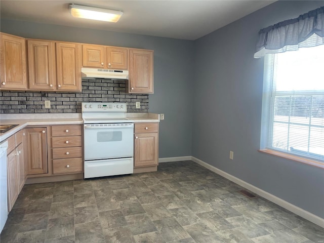 kitchen featuring baseboards, under cabinet range hood, light countertops, decorative backsplash, and electric stove