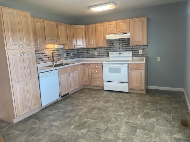 kitchen featuring white appliances, light brown cabinetry, a sink, light countertops, and under cabinet range hood