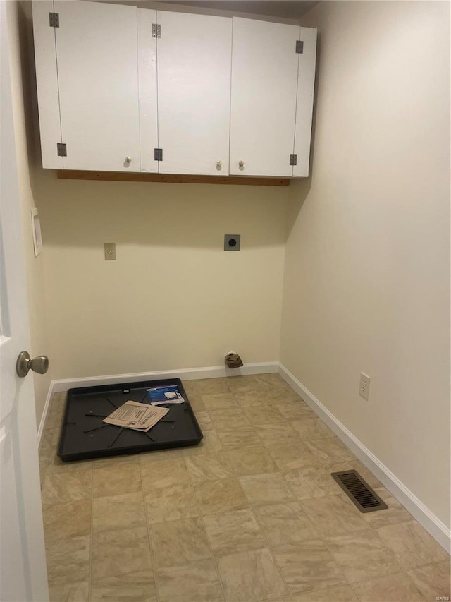 clothes washing area with cabinet space, baseboards, visible vents, and electric dryer hookup