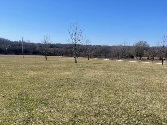 view of home's community featuring a yard and a rural view