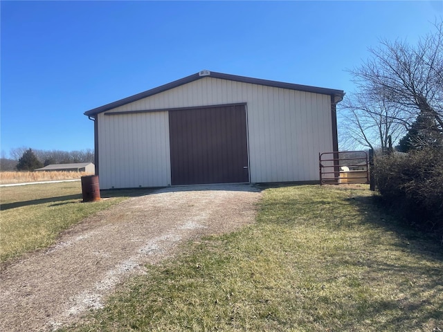 view of pole building with a lawn and driveway