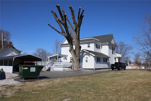 view of property exterior with a carport and a yard