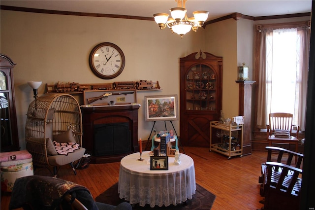 living room featuring wood finished floors, a fireplace, and ornamental molding