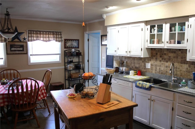 kitchen featuring white cabinetry, a sink, decorative backsplash, dishwasher, and crown molding