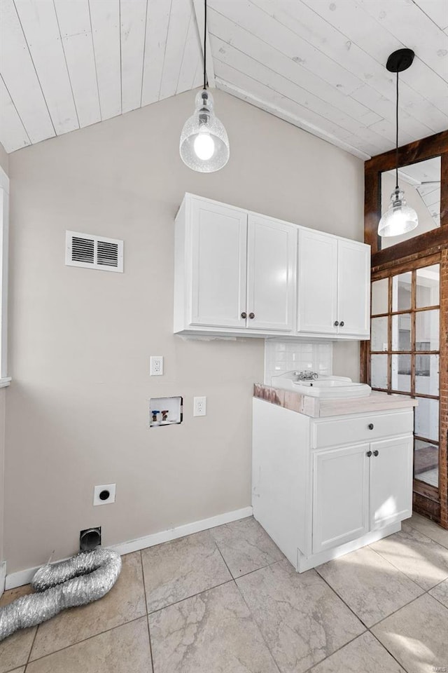 laundry room with visible vents, baseboards, hookup for a washing machine, cabinet space, and hookup for an electric dryer