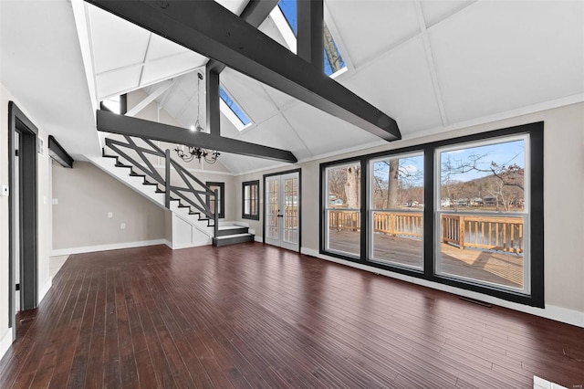 unfurnished living room with stairs, baseboards, and wood finished floors