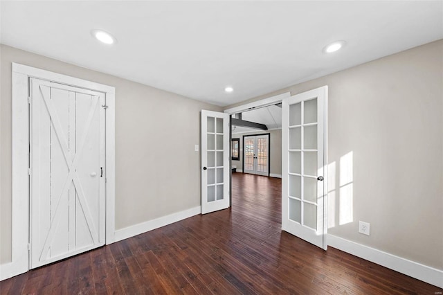 spare room with recessed lighting, french doors, baseboards, and hardwood / wood-style floors