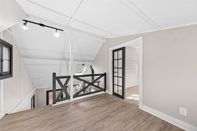 bonus room with baseboards, wood finished floors, and vaulted ceiling