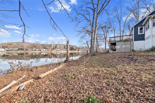 view of yard with a deck with water view