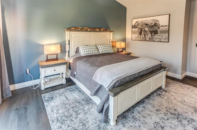 bedroom with baseboards and wood finished floors