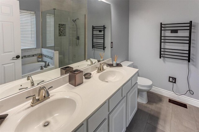 bathroom featuring a shower stall, radiator heating unit, and a sink