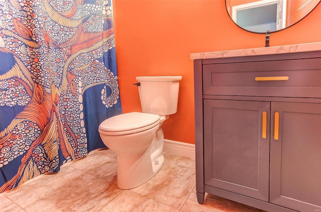 bathroom with a sink, baseboards, and toilet