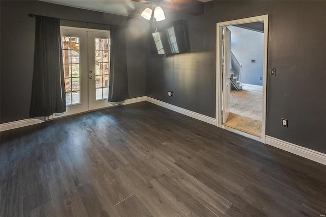 unfurnished dining area featuring stairs, french doors, dark wood-style flooring, and baseboards