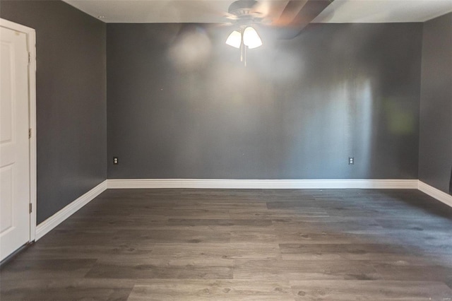 spare room with ceiling fan, baseboards, and wood finished floors