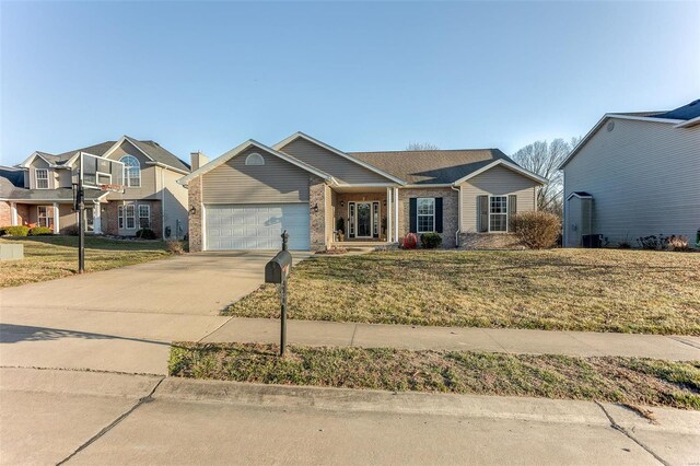 view of front of property with a garage, brick siding, concrete driveway, and a front yard