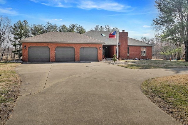 ranch-style home featuring concrete driveway, an attached garage, brick siding, and a chimney