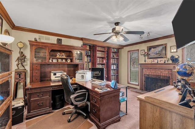 office featuring visible vents, light carpet, crown molding, a brick fireplace, and ceiling fan