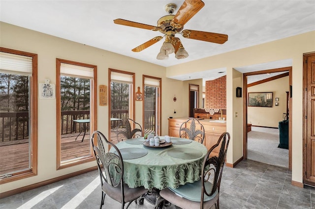 dining room with baseboards, ceiling fan, and vaulted ceiling