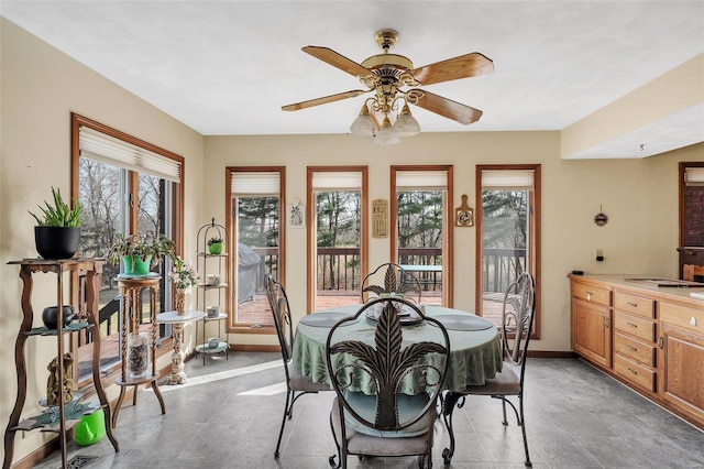 dining room featuring baseboards and a ceiling fan