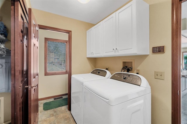 laundry room featuring cabinet space, independent washer and dryer, and baseboards