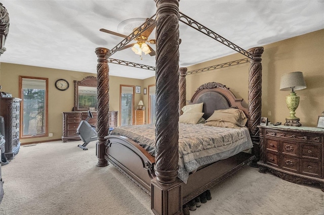 bedroom with light carpet, baseboards, and ceiling fan