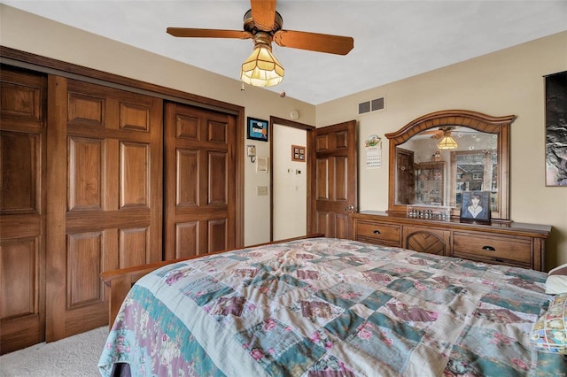 bedroom with visible vents, carpet, a closet, and a ceiling fan