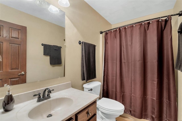 bathroom with a shower with curtain, toilet, and vanity