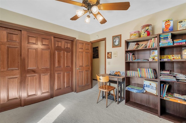 home office with a ceiling fan and light colored carpet