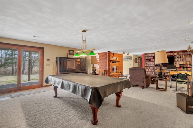 recreation room with carpet flooring, pool table, and a textured ceiling