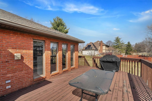 wooden terrace featuring area for grilling