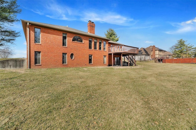 rear view of property featuring stairway, a lawn, brick siding, and a chimney