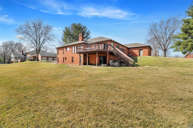 back of property featuring brick siding, stairway, a lawn, a chimney, and a deck