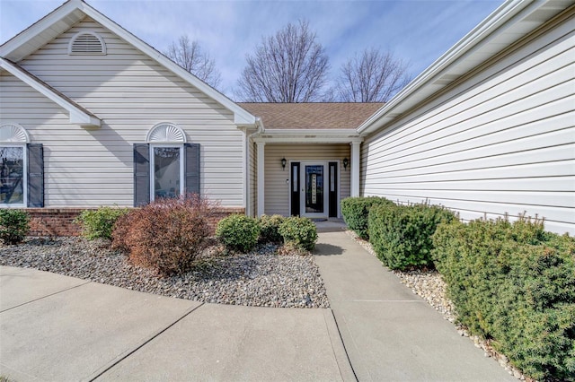 property entrance featuring brick siding