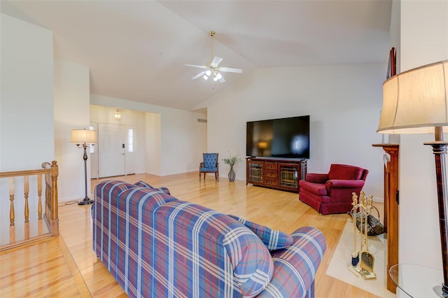 living room with light wood finished floors, baseboards, lofted ceiling, and a ceiling fan