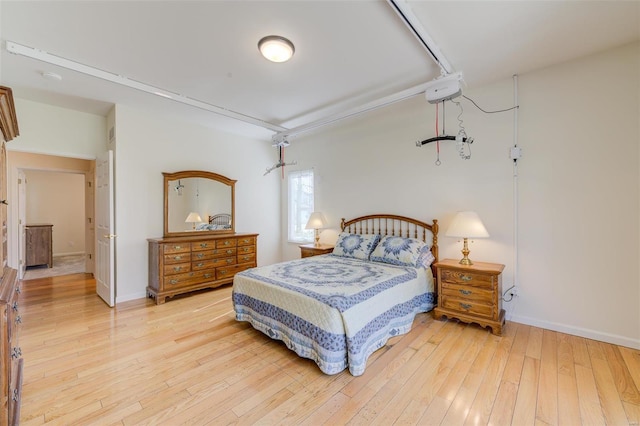 bedroom with baseboards and light wood finished floors