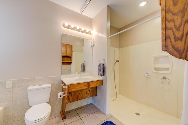 bathroom featuring a shower, toilet, tile walls, and tile patterned flooring