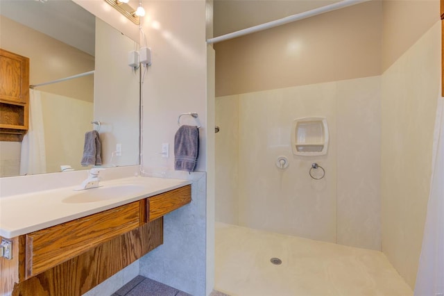 bathroom featuring vanity and a shower