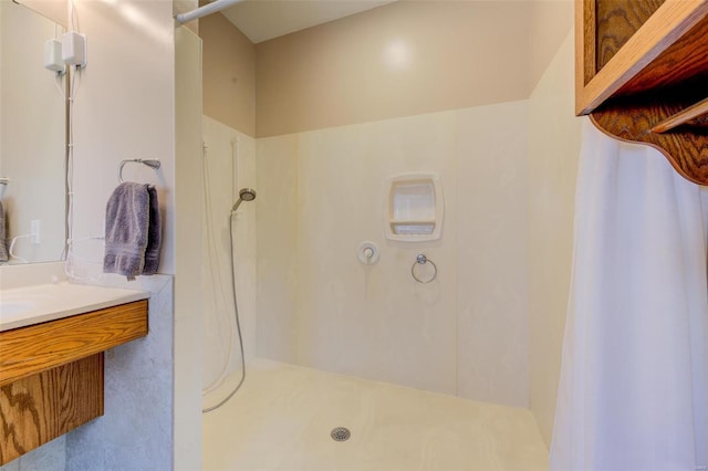 bathroom featuring a shower and vanity