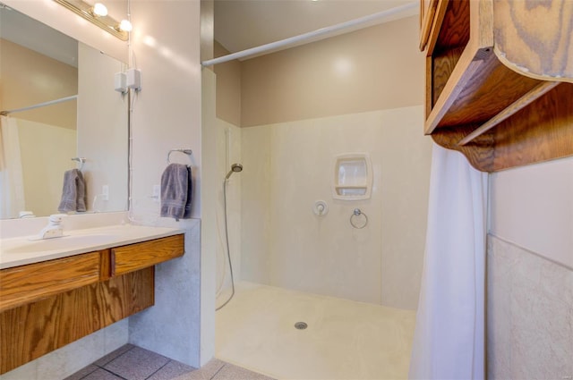 full bathroom featuring curtained shower, vanity, and tile patterned flooring