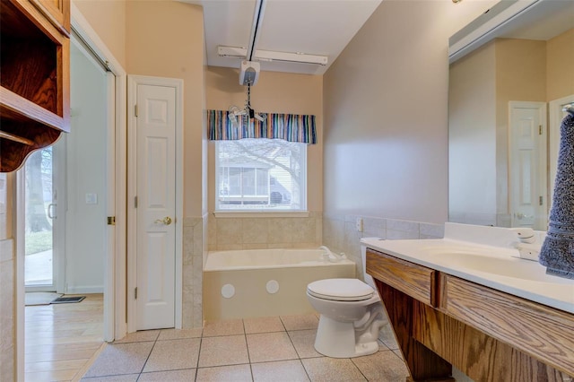 bathroom with tile patterned flooring, a healthy amount of sunlight, vanity, and a garden tub