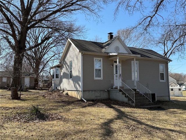 view of front facade featuring crawl space and a chimney