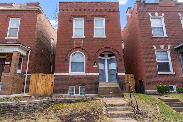 view of front of property with entry steps and brick siding