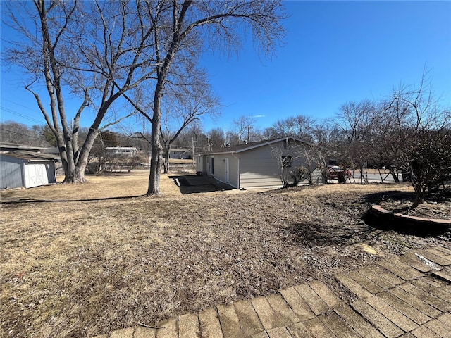 view of yard featuring an outbuilding and a storage shed