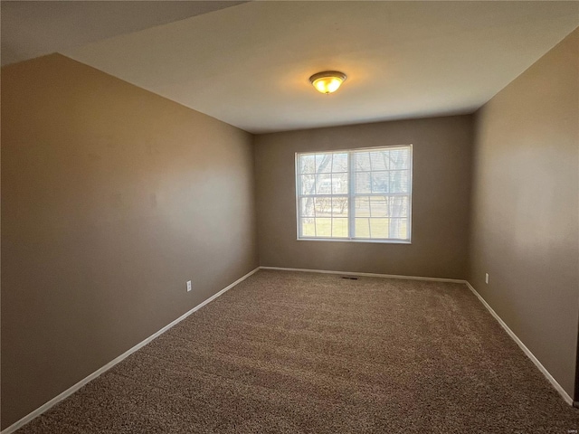 carpeted spare room with baseboards