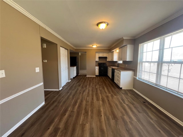 kitchen with baseboards, dishwasher, ornamental molding, stove, and white cabinetry