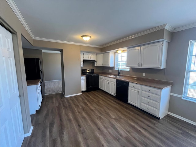 kitchen featuring black appliances, ornamental molding, a sink, white cabinets, and dark wood-style flooring