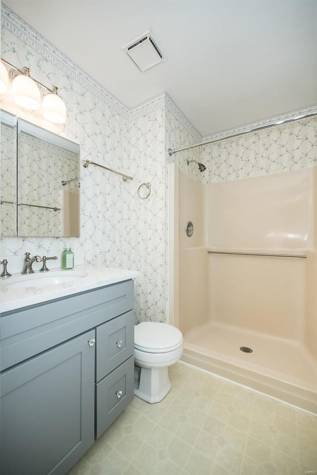 full bathroom featuring visible vents, wallpapered walls, walk in shower, toilet, and vanity