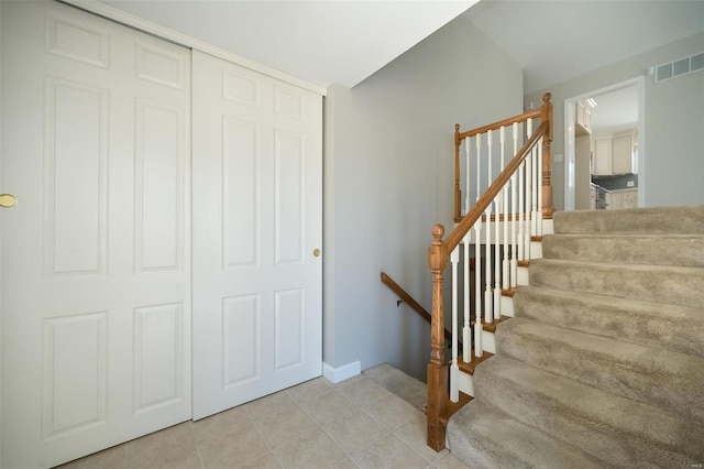 stairs featuring tile patterned flooring and visible vents